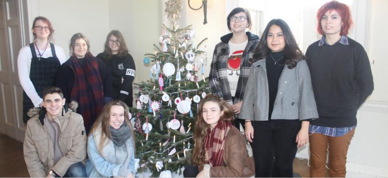 students gathered around Christmas tree